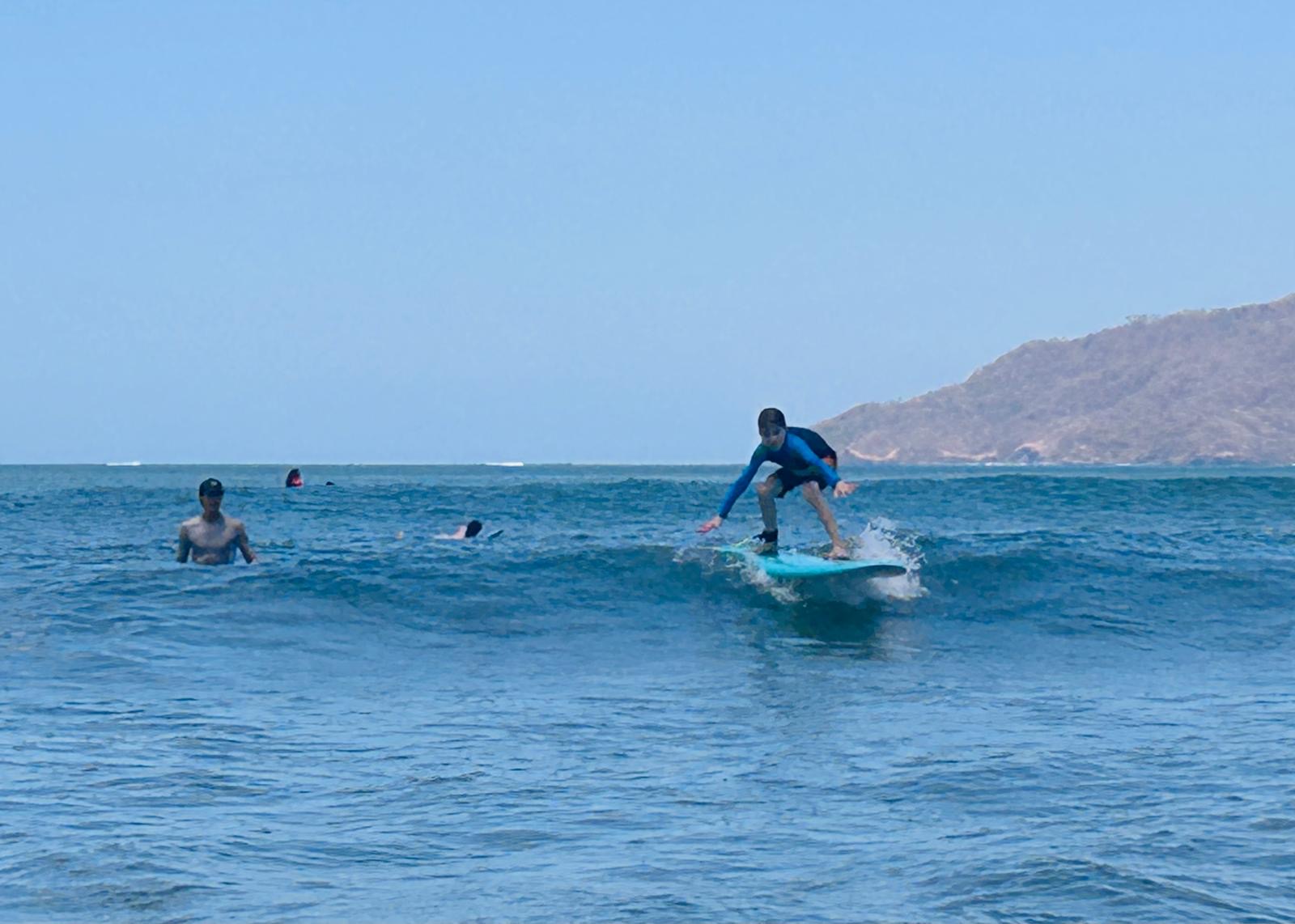 Surf student riding a wave