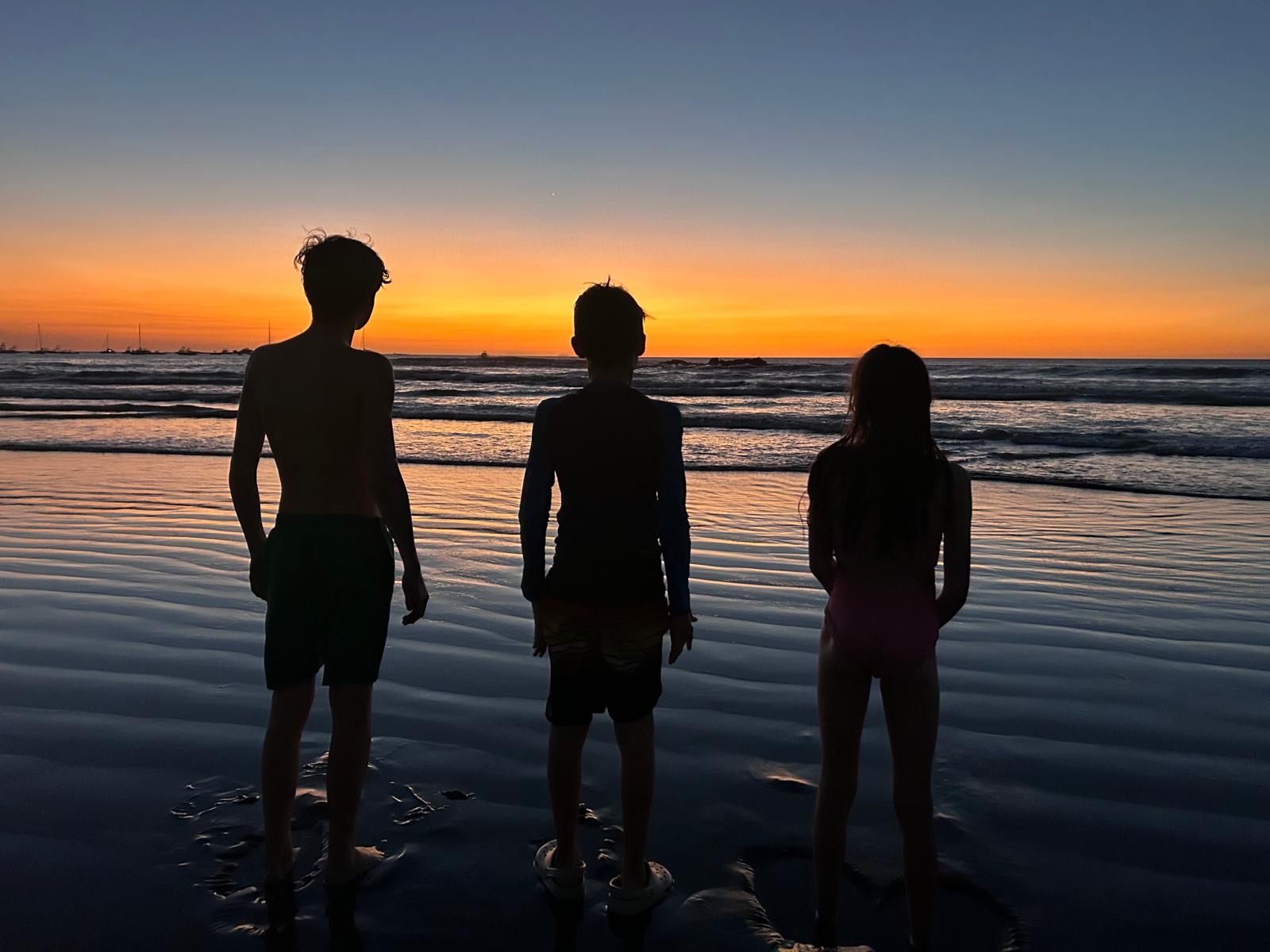 Surfers enjoying a Tamarindo sunset