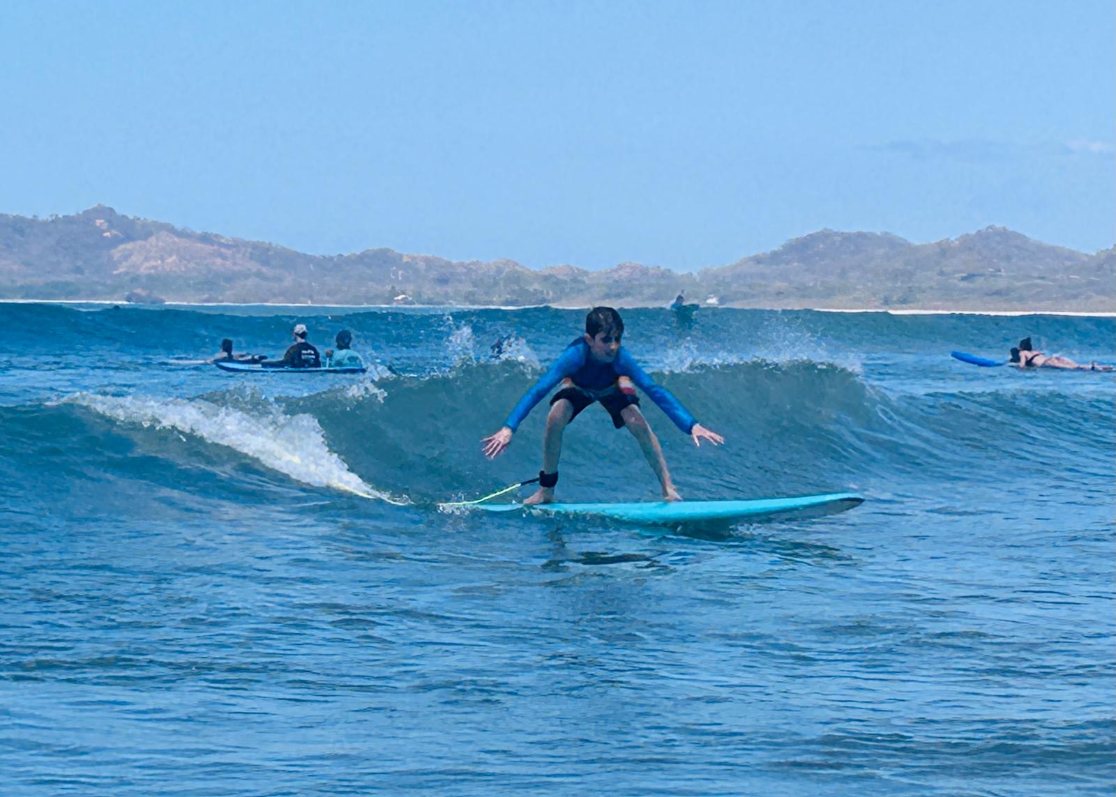 Surf student riding a wave in Costa Rica