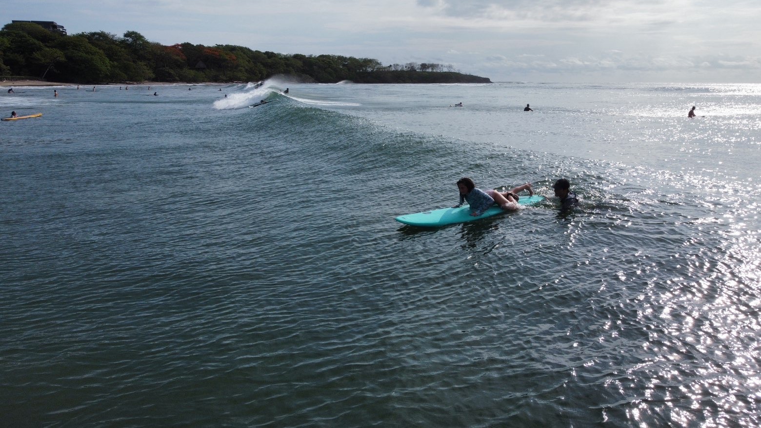 Student catching a wave during a surf lesson