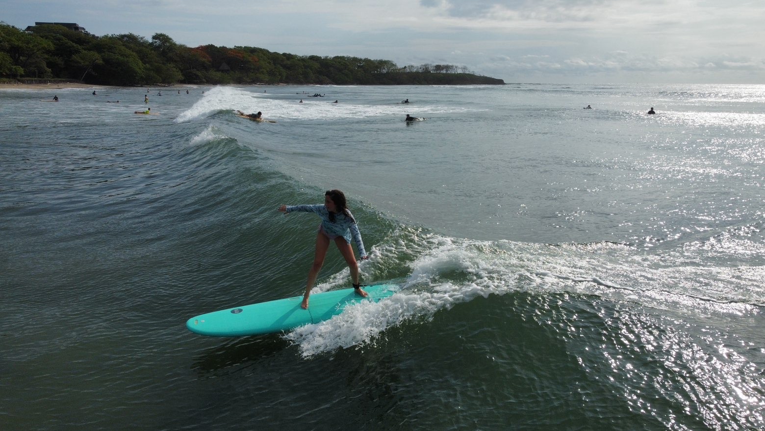Surf student riding a wave in Tamarindo