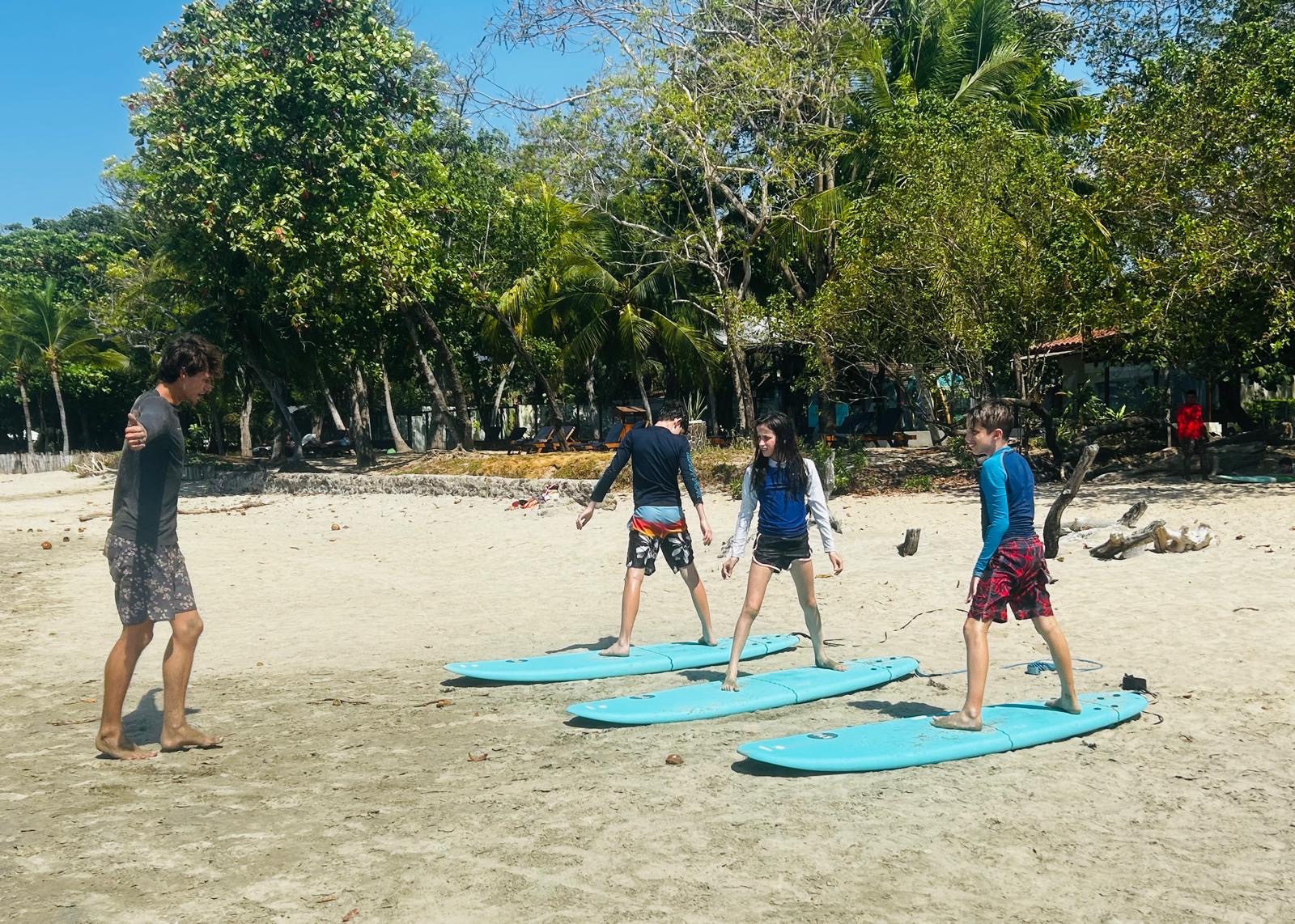 Students practicing surf technique on the beach